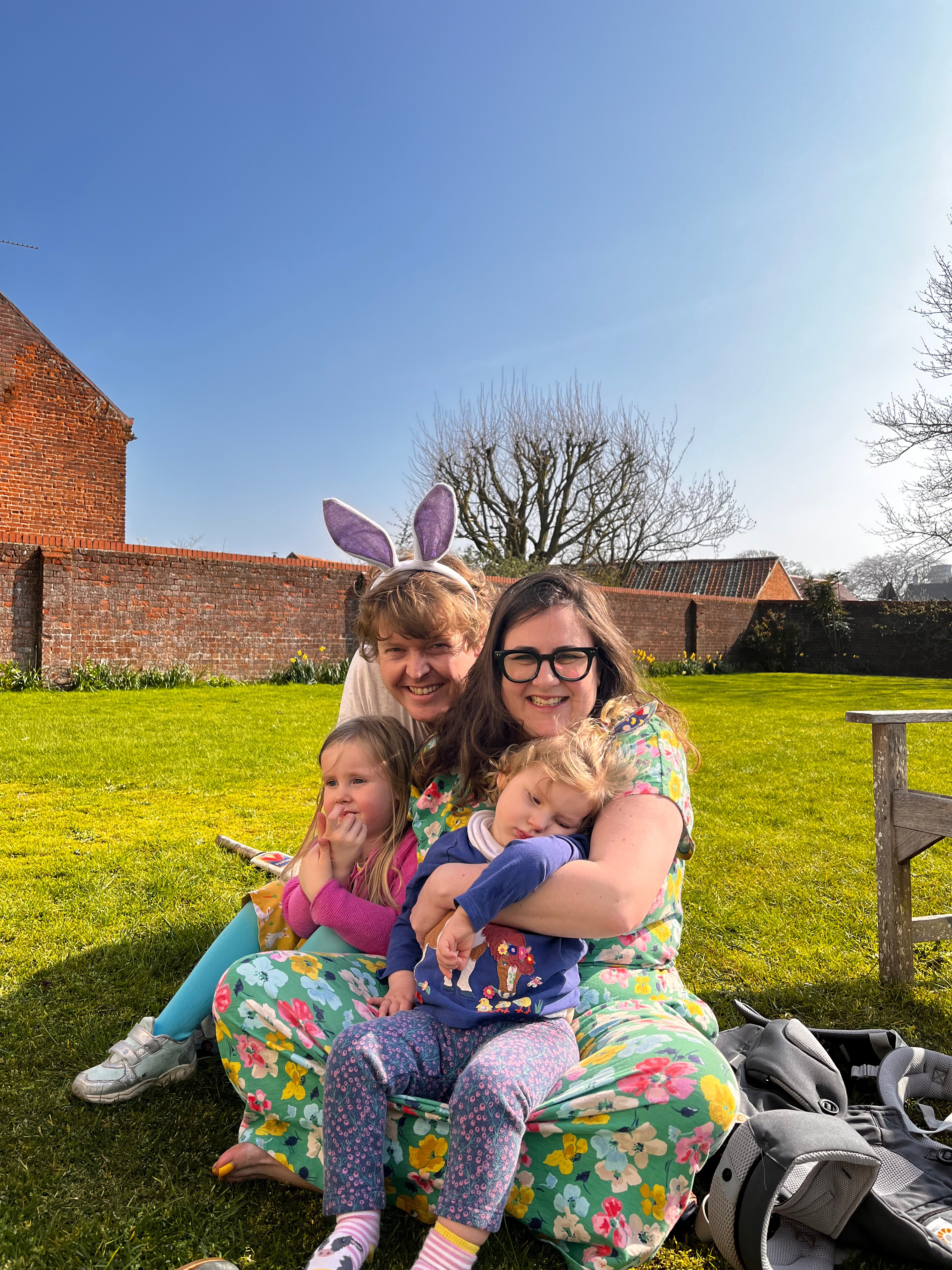 Image of Emmy with her mum, dad and sister in the garden